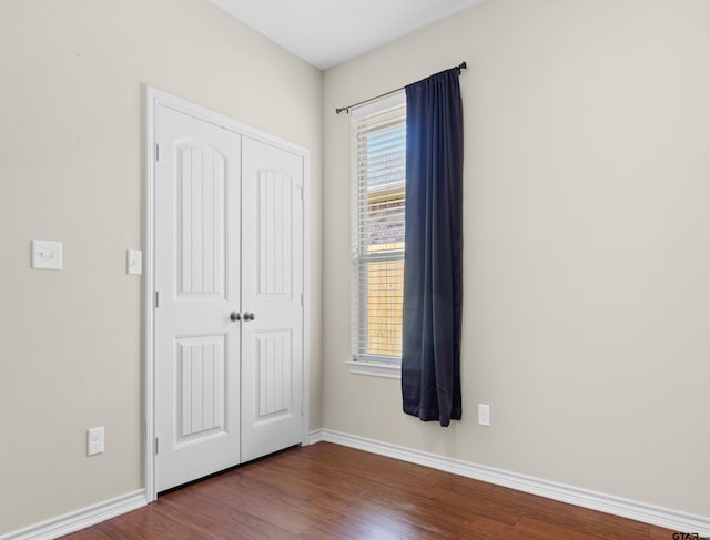 unfurnished bedroom featuring hardwood / wood-style floors and a closet