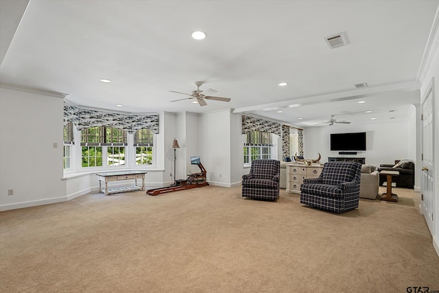 living room featuring ceiling fan, light carpet, and ornamental molding