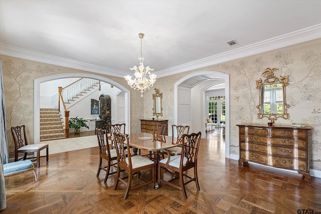 dining space featuring a chandelier, crown molding, and dark parquet floors