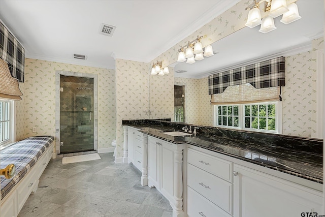 bathroom with walk in shower, vanity, and ornamental molding