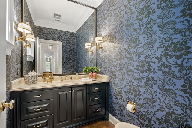 bathroom featuring vanity, hardwood / wood-style floors, and ornamental molding