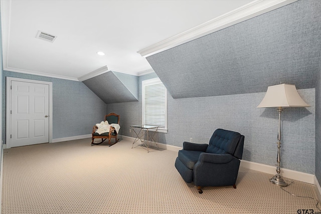 sitting room with vaulted ceiling, crown molding, and carpet floors