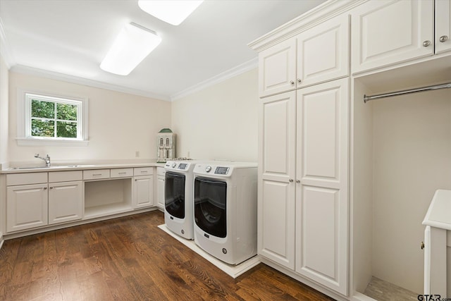 laundry area with cabinets, sink, crown molding, washer and dryer, and dark hardwood / wood-style flooring