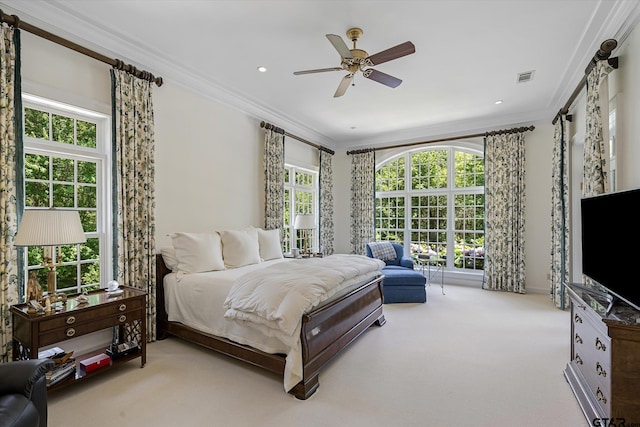 bedroom featuring multiple windows, light carpet, ceiling fan, and crown molding