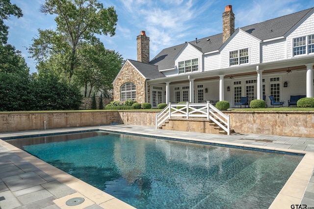 view of pool featuring french doors, ceiling fan, and a patio