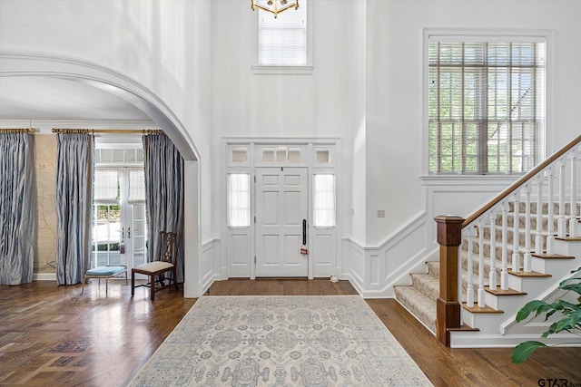 entrance foyer featuring plenty of natural light and dark hardwood / wood-style floors