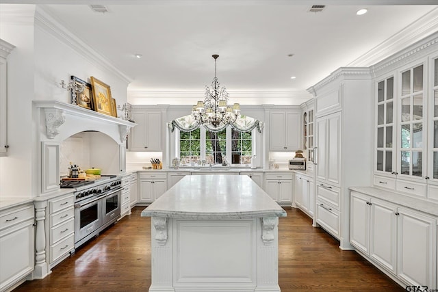 kitchen featuring white cabinets, range with two ovens, dark hardwood / wood-style flooring, and a center island