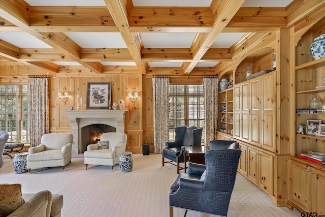 living area with a wealth of natural light, light colored carpet, wooden walls, and coffered ceiling