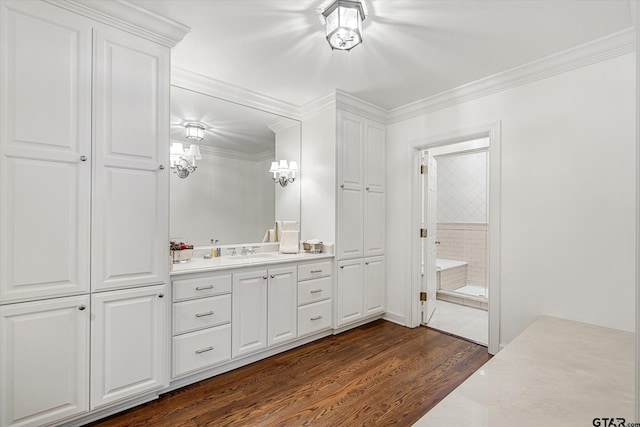 bathroom featuring ornamental molding, vanity, and hardwood / wood-style flooring