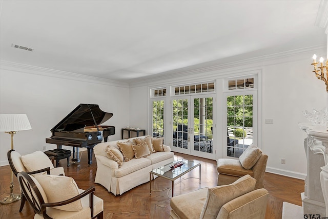 living room with french doors, crown molding, dark parquet floors, and an inviting chandelier