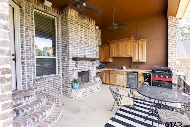 521 Susie St, Chandler, TX 75758 - view of patio / terrace featuring beverage cooler, area for grilling, a ceiling fan, outdoor dining space, and a sink