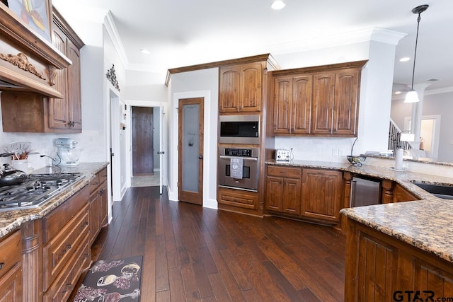 521 Susie St, Chandler, TX 75758 - kitchen with appliances with stainless steel finishes, crown molding, light stone countertops, tasteful backsplash, and dark wood finished floors