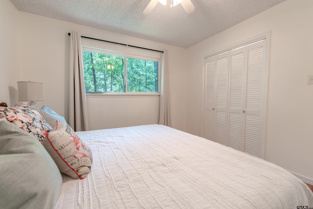 506 S King Lake Rd, Scroggins, TX 75480 - bedroom with a textured ceiling, a closet, and a ceiling fan