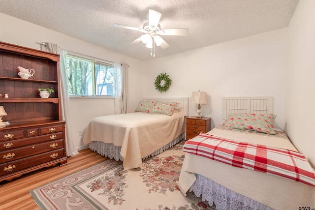 506 S King Lake Rd, Scroggins, TX 75480 - bedroom featuring light wood finished floors, a textured ceiling, and ceiling fan