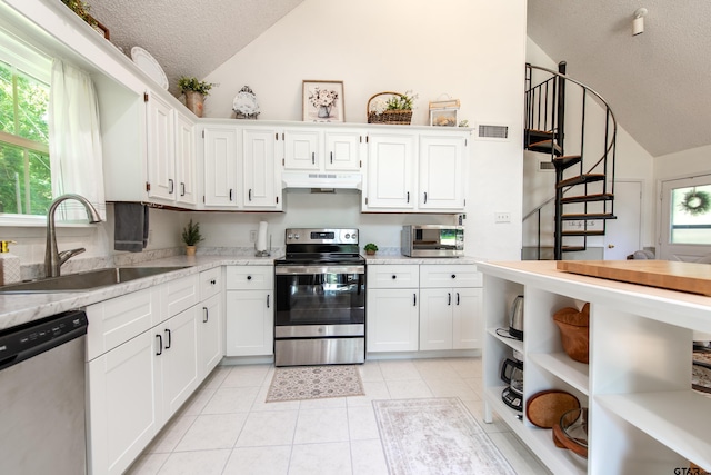 506 S King Lake Rd, Scroggins, TX 75480 - kitchen featuring appliances with stainless steel finishes, under cabinet range hood, a sink, a textured ceiling, and white cabinetry