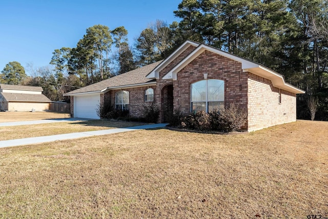 view of front of house featuring a garage and a front lawn