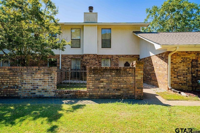 rear view of property with a yard