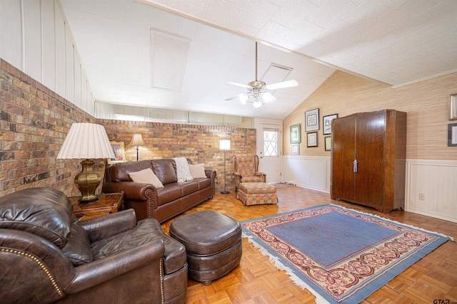 living room featuring brick wall, parquet flooring, ceiling fan, and vaulted ceiling