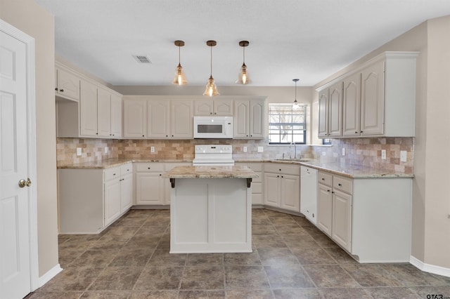 314 Briarcrest Dr, Chandler, TX 75758 - kitchen with backsplash, a center island, a sink, and white appliances