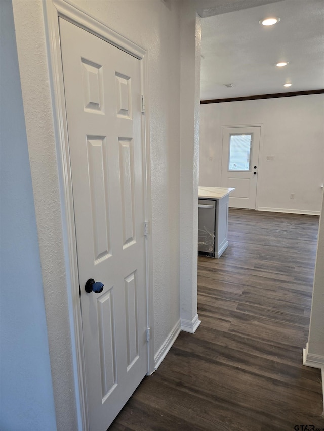 hallway featuring ornamental molding and dark hardwood / wood-style flooring