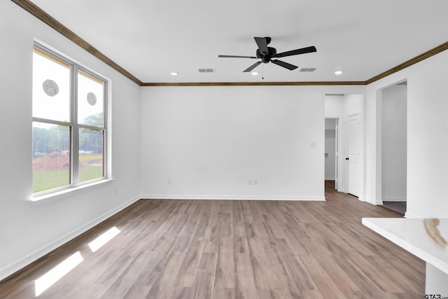 interior space with a ceiling fan, baseboards, and crown molding