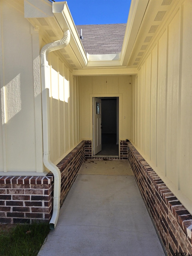 view of exterior entry with a patio