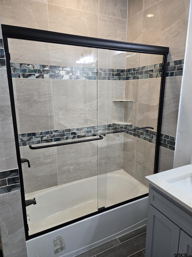 bathroom with vanity and enclosed tub / shower combo