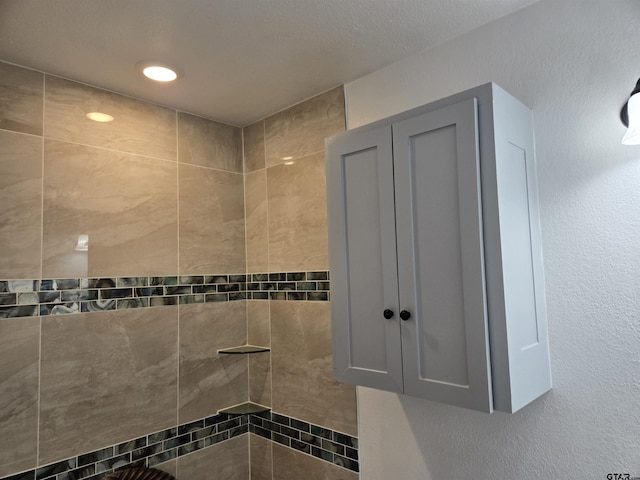 bathroom with tiled shower