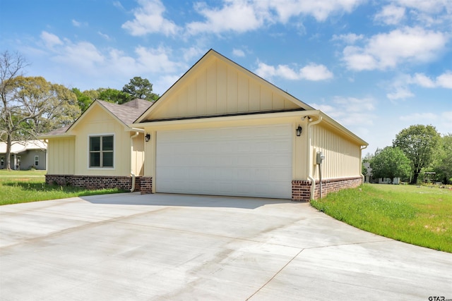 view of front of property featuring brick siding, driveway, board and batten siding, and a garage