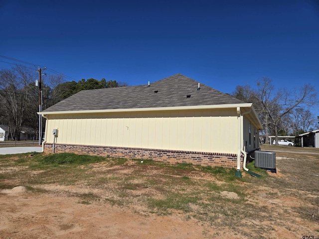 view of side of home with central AC