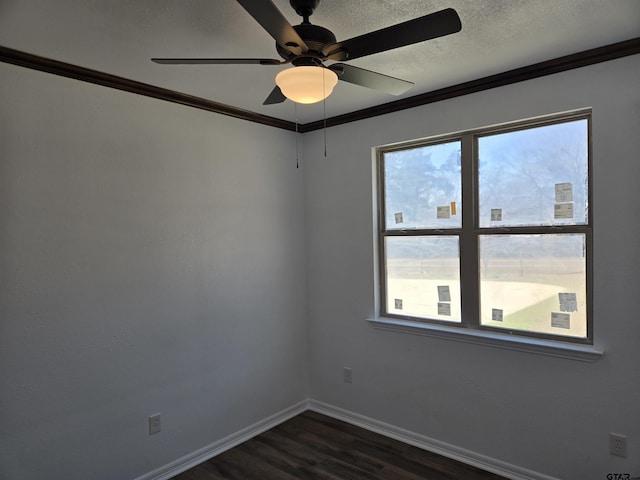 spare room featuring crown molding, a healthy amount of sunlight, and dark hardwood / wood-style floors