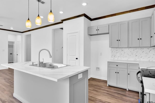 kitchen featuring backsplash, black range with electric stovetop, a sink, crown molding, and pendant lighting