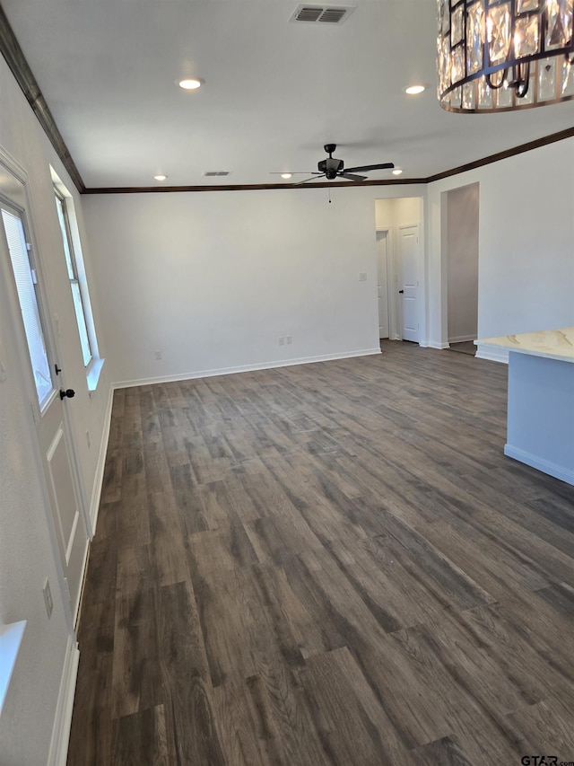 unfurnished living room featuring crown molding, ceiling fan, and dark hardwood / wood-style floors