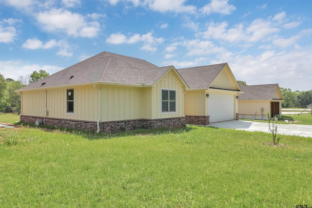 view of front of property featuring concrete driveway, an attached garage, board and batten siding, roof with shingles, and a front yard