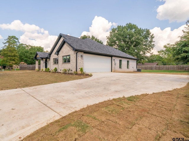 view of side of property featuring a lawn, a garage, and cooling unit