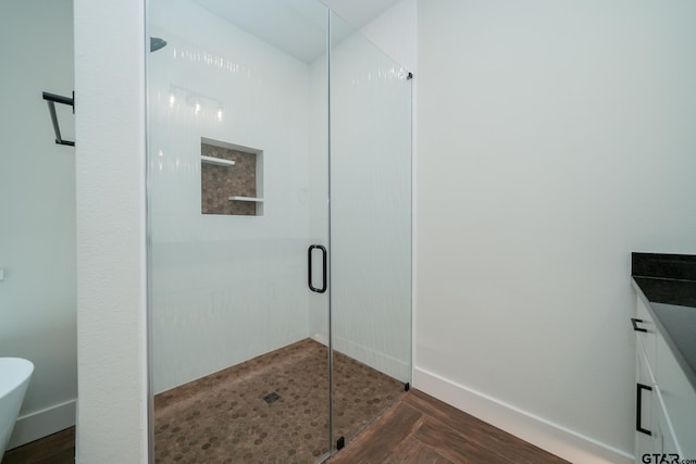 bathroom featuring wood-type flooring and an enclosed shower