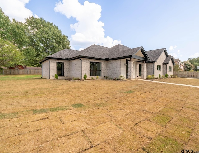 french country home featuring a front lawn