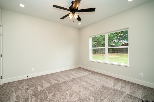 empty room with ceiling fan and carpet floors