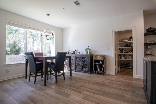 1224 Nate Cir, Bullard, TX 75757 - dining space featuring a notable chandelier, baseboards, visible vents, and wood finished floors