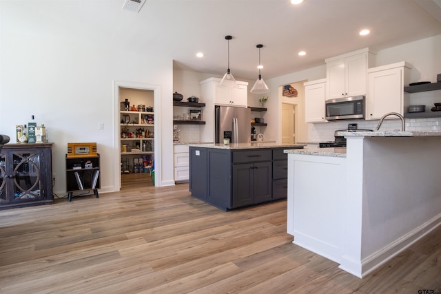 1224 Nate Cir, Bullard, TX 75757 - kitchen featuring visible vents, open shelves, appliances with stainless steel finishes, white cabinetry, and light wood-type flooring