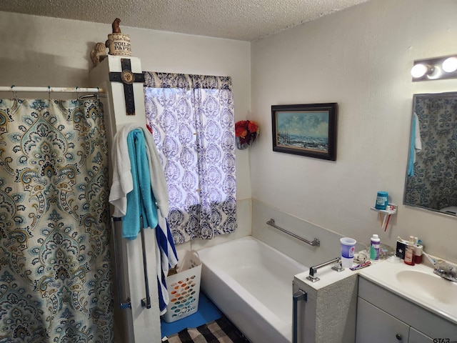 bathroom featuring vanity, a textured ceiling, and shower with separate bathtub