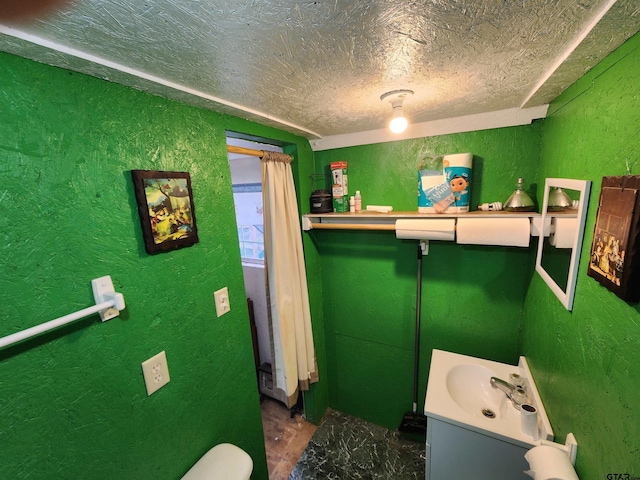 bathroom featuring a textured ceiling and vanity