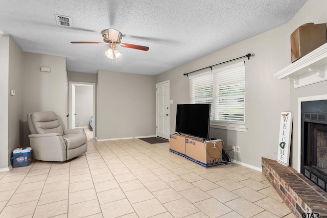 18396 Tall Pines Dr, Tyler, TX 75703 - living room featuring a ceiling fan, a fireplace, a textured ceiling, and baseboards