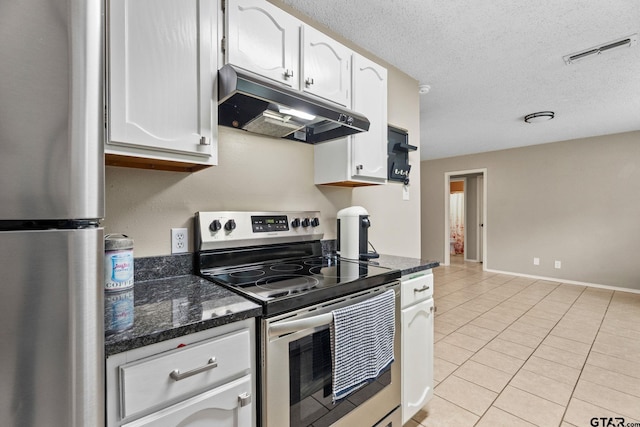 18396 Tall Pines Dr, Tyler, TX 75703 - kitchen featuring under cabinet range hood, stainless steel appliances, white cabinets, light tile patterned floors, and a textured ceiling