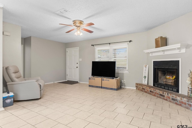 18396 Tall Pines Dr, Tyler, TX 75703 - living room with a ceiling fan, a fireplace, baseboards, and a textured ceiling