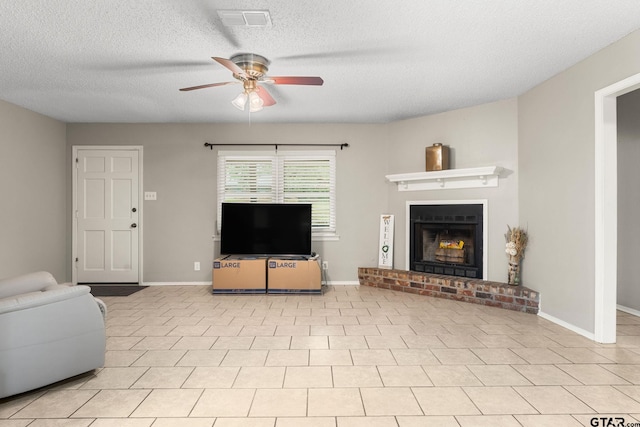 18396 Tall Pines Dr, Tyler, TX 75703 - living room featuring a ceiling fan, a textured ceiling, a brick fireplace, and baseboards