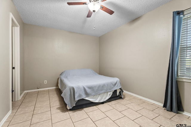 18396 Tall Pines Dr, Tyler, TX 75703 - bedroom with a textured ceiling, light tile patterned floors, ceiling fan, and baseboards