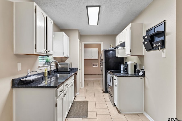18396 Tall Pines Dr, Tyler, TX 75703 - kitchen featuring stainless steel appliances, a sink, white cabinetry, baseboards, and a textured ceiling