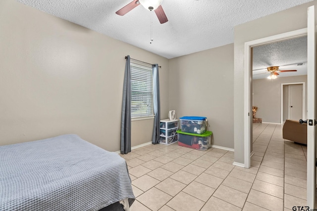 18396 Tall Pines Dr, Tyler, TX 75703 - bedroom with a textured ceiling, light tile patterned floors, ceiling fan, and baseboards