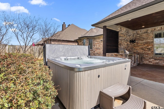 view of patio / terrace with central air condition unit and a hot tub